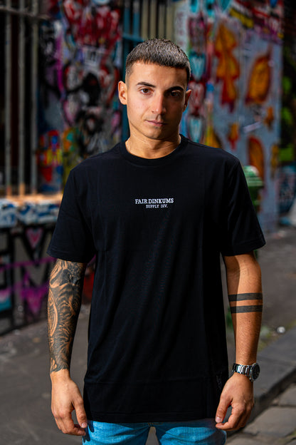 Fair Dinkums Supima Cotton Tee — Black (White Embroidery & Hem Print)